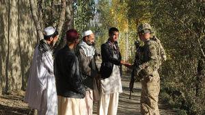 U.S. troops from the 1-91 Cavalry question Afghan civilians in Baraki Barak district in Logar Province, south of Kabul.