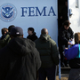 Residents wait for information from FEMA in the Rockaway neighborhood of Queens, N.Y. Superstorm Sandy washed away a large section of the iconic boardwalk here on Nov. 2.