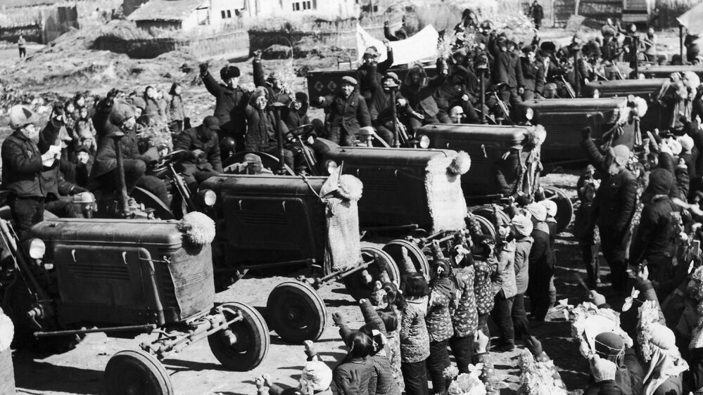 Chinese villagers welcome the arrival of tractors purchased by a farmers' cooperative in April 1958, during the Great Leap Forward campaign. The disastrous modernization program ended in China's great famine and tens of millions of deaths.