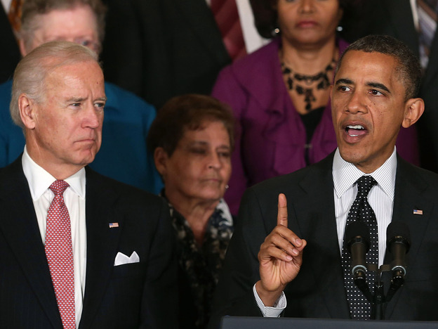Vice President Biden looks on as President Obama speaks at the White House.