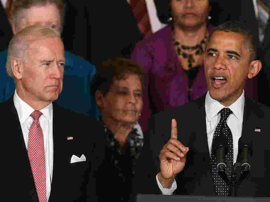 Vice President Biden looks on as President Obama speaks at the White House.