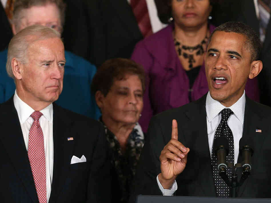 Vice President Biden looks on as President Obama speaks at the White House.