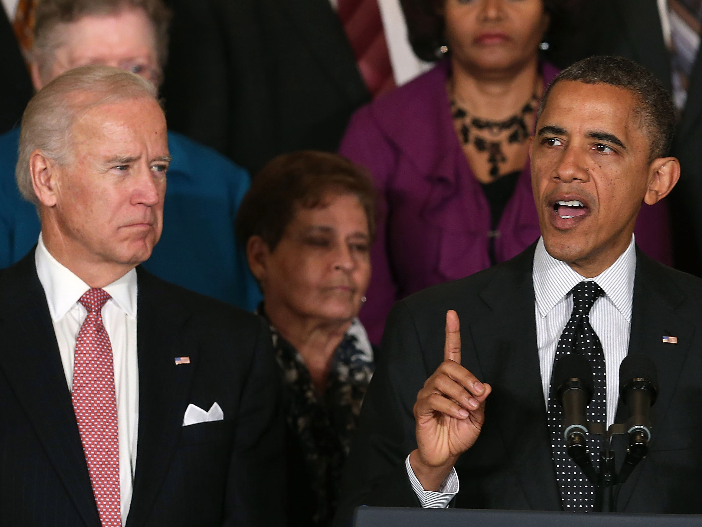 Vice President Biden looks on as President Obama speaks at the White House.