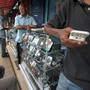 Men look at mobile phones at the Adjame market in Abidjan, Ivory Coast. The market for mobile telephones in developing countries has grown quickly, and now Facebook and Google are trying to get users to use the Internet on their devices.