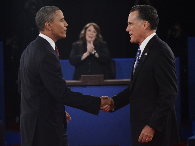 Moderator Candy Crowley applauds as President Obama shakes hands with former Massachusetts Gov. Mitt Romney during the second presidential debate on Oct. 16.