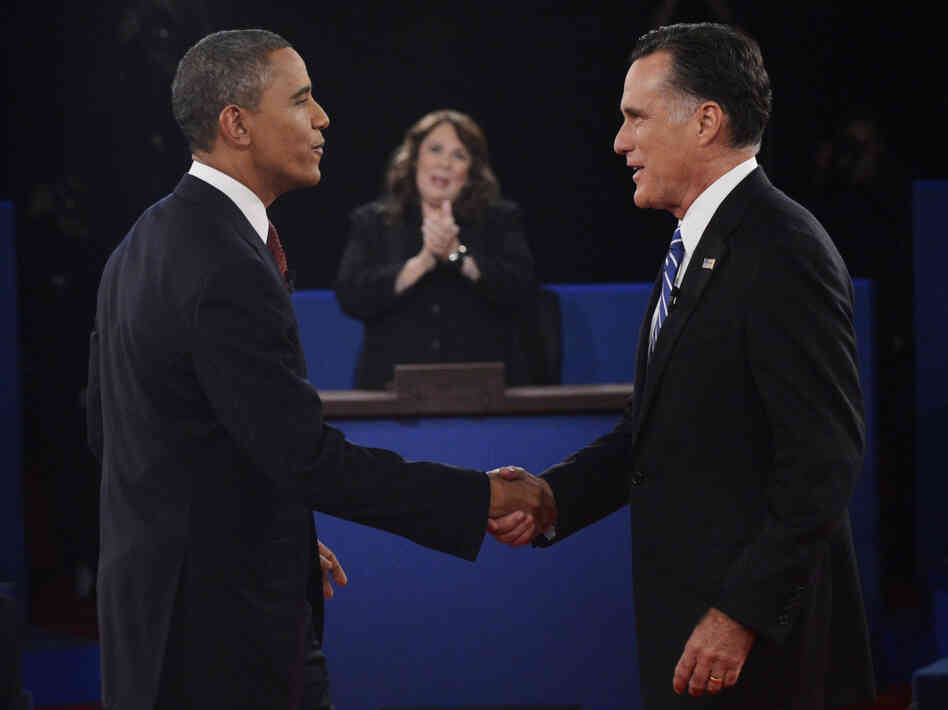 Moderator Candy Crowley applauds as President Obama shakes hands with former Massachusetts Gov. Mitt Romney during the second presidential debate on Oct. 16.