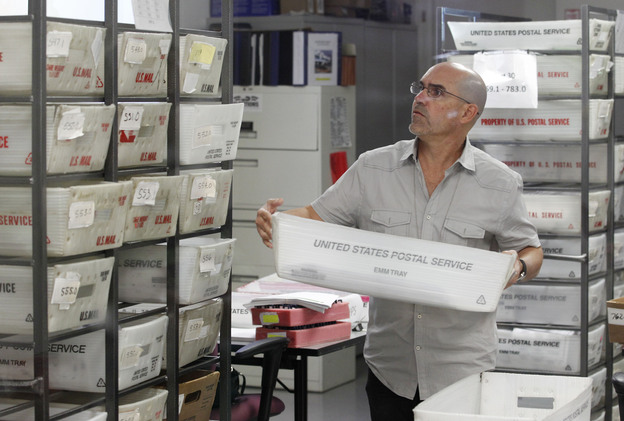 A worker prepares boxes of absentee ballots to be scanned at the Miami-Dade County Elections Department on Tuesday.