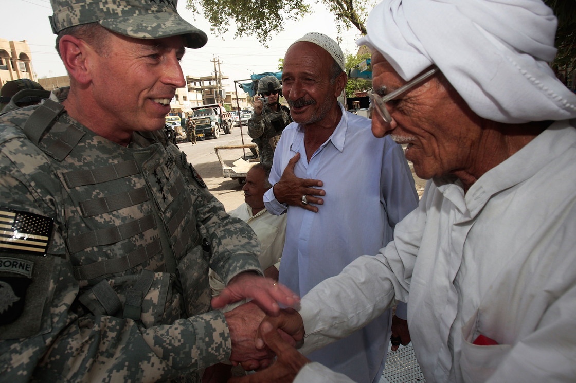 Gen. David Petraeus greets an Iraqi man at a tea shop in Baghdad in 2007. In 2011, Petraeus left the Army to become CIA director. He resigned Friday, citing an extramarital affair.