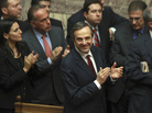 Greek Prime Minister Antonis Samaras and lawmakers from his New Democracy applaud after voting on the country's 2013 budget in Athens early Monday. Greek lawmakers approved the country's 2013 austerity budget, an essential step in Greece's efforts to persuade its international creditors to unblock a vital rescue loan installment without which the country will go bankrupt. Greek Prime Minister Antonis Samaras and lawmakers from his New Democracy applaud after voting on the country's 2013 budget in Athens early Monday. Greek lawmakers approved the country's 2013 austerity budget, an essential step in Greece's efforts to persuade its international creditors to unblock a vital rescue loan installment without which the country will go bankrupt.