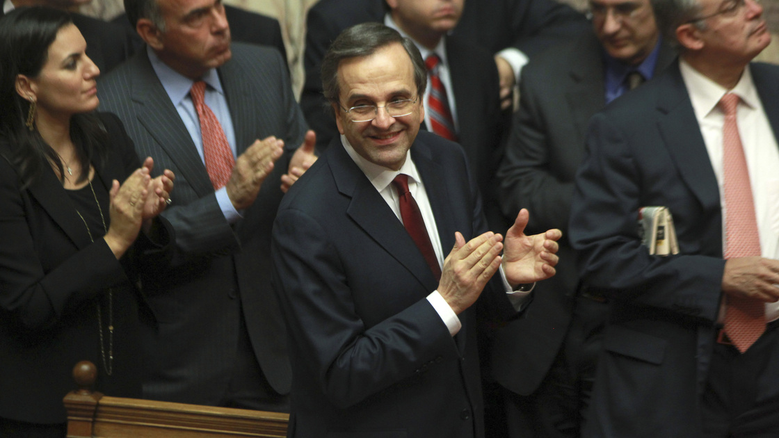 Greek Prime Minister Antonis Samaras and lawmakers from his New Democracy applaud after voting on the country's 2013 budget in Athens early Monday. Greek lawmakers approved the country's 2013 austerity budget, an essential step in Greece's efforts to persuade its international creditors to unblock a vital rescue loan installment without which the country will go bankrupt.