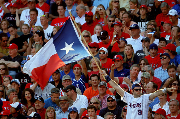 A fan holds up the Texas state flag during Game Two of the ALCS during the 2010 MLB Playoffs.
