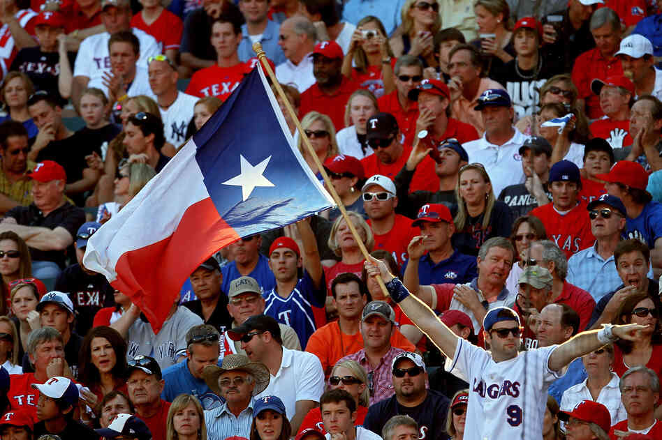 A fan holds up the Texas state flag during Game Two of the ALCS during the 2010 MLB Playoffs.