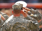 Major Ehyart of the US Army salutes during the national anthem during a game between the Miami Dolphins and the Tennessee Titans at Sun Life Stadium on November 11, 2012 in Miami Gardens, Florida. Major Ehyart of the US Army salutes during the national anthem during a game between the Miami Dolphins and the Tennessee Titans at Sun Life Stadium on November 11, 2012 in Miami Gardens, Florida.
