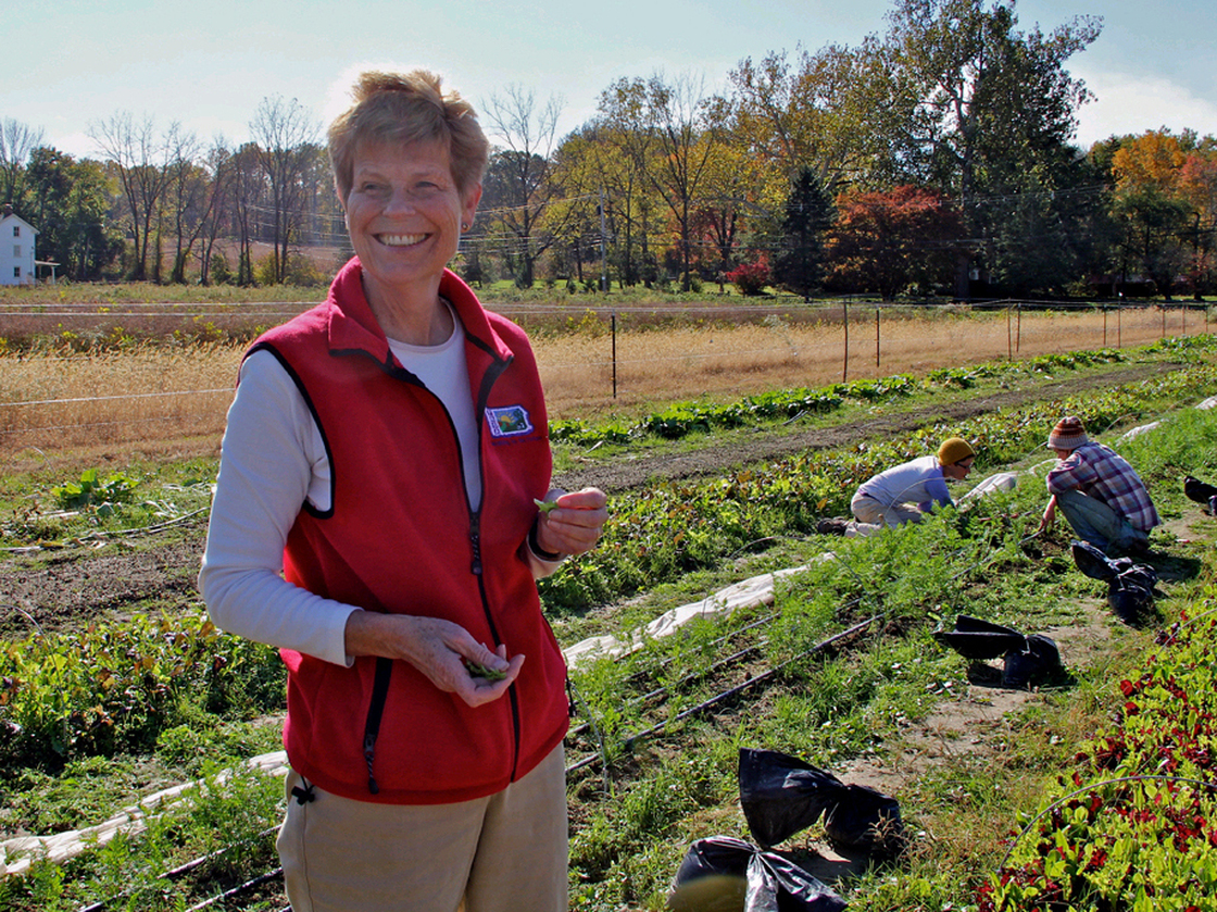 Eleanor Morris Illoway samples greens from farmland that she leased to organic farmers.