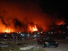 Flames shot high in the sky Saturday at the scene of the explosion and fire in Indianapolis. Flames shot high in the sky Saturday at the scene of the explosion and fire in Indianapolis.