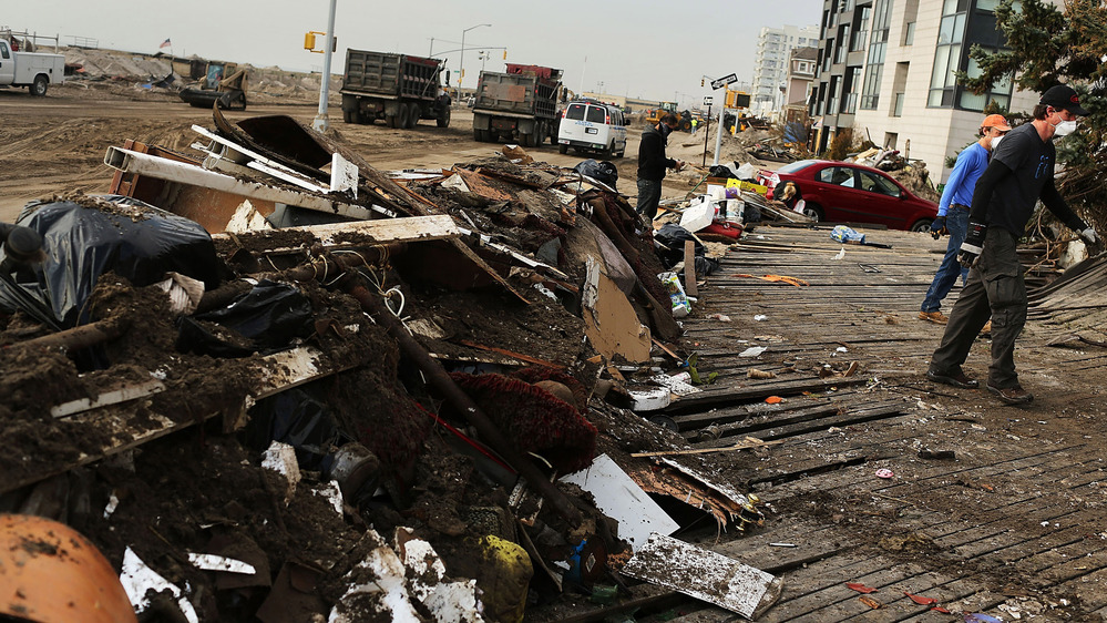 Volunteers help to clean up in the heavily damaged Rockaway neighborhood where a large section of the iconic boardwalk was washed away.