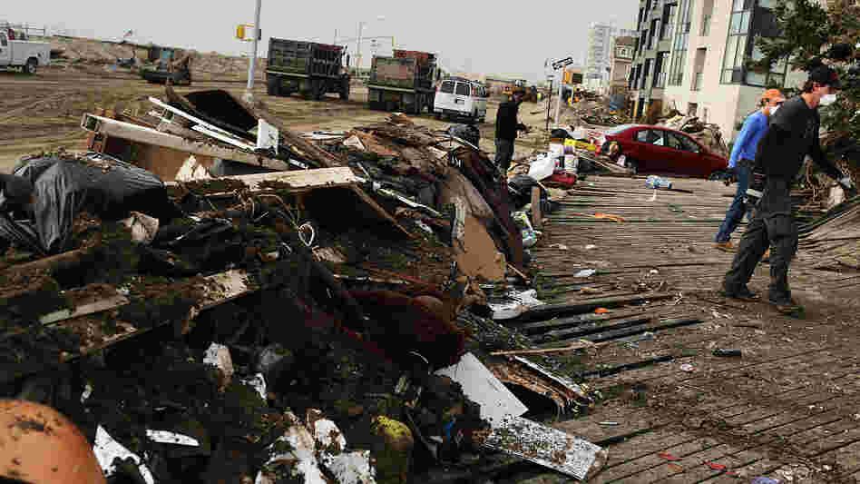 Volunteers help to clean up in the heavily damaged Rockaway neighborhood where a large section of the iconic boardwalk was washed away.