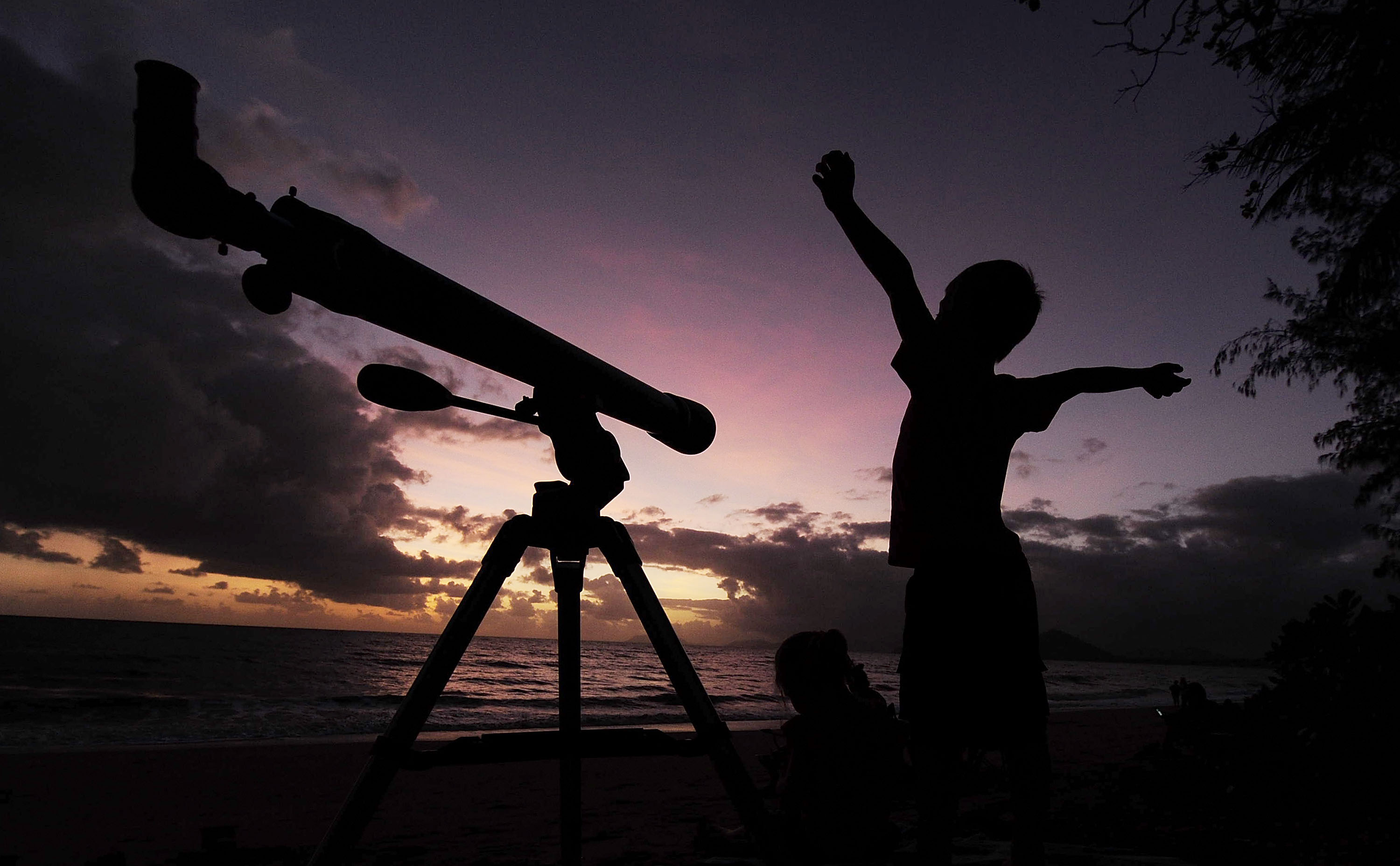 A young boy gets ready to view the solar eclipse with his telescope on Wednesday. 
