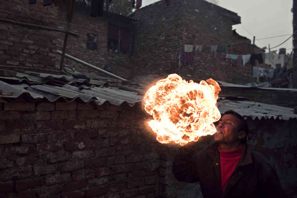 A fire-breather in the Kathputli Colony, New Delhi, India. A fire-breather in the Kathputli Colony, New Delhi, India.