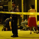Paramedics treat multiple gunshot victims in Chicago in August.