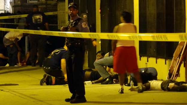 Paramedics treat multiple gunshot victims in Chicago in August. (MCT/Landov)