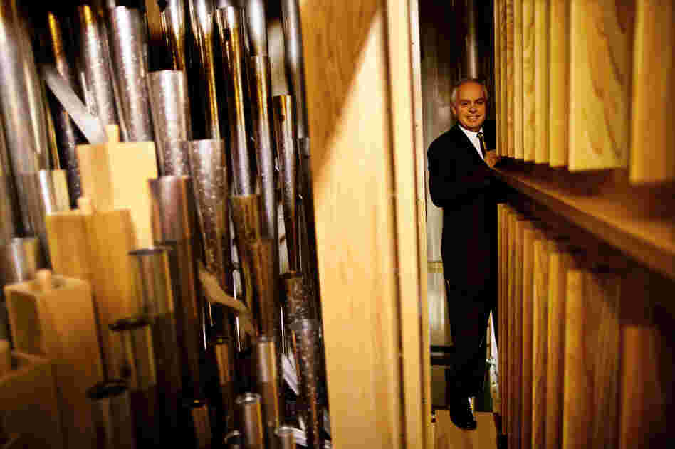 Rochette stands along a narrow passageway deep inside the organ chamber.