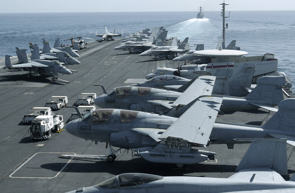 The U.S. maintains a strong naval presence in the Persian Gulf in order to safeguard key shipping lanes. Here, aircraft are parked on the flight deck of the USS Abraham Lincoln as a U.S. destroyer patrols the Arabian Sea in the Strait of Hormuz in February.