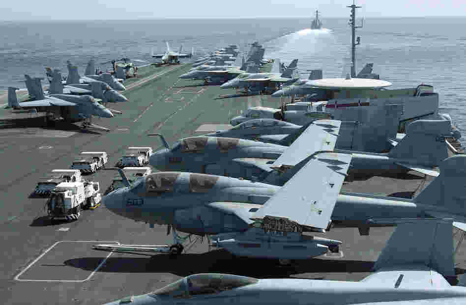 The U.S. maintains a strong naval presence in the Persian Gulf in order to safeguard key shipping lanes. Here, aircraft are parked on the flight deck of the USS Abraham Lincoln as a U.S. destroyer patrols the Arabian Sea in the Strait of Hormuz in February.
