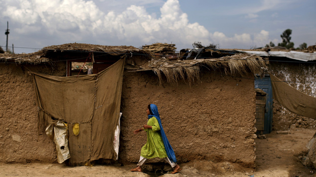 An Afghan refugee girl walks back to her home in a slum on the outskirts of the Pakistani capital, Islamabad, in August. She is one of an estimated 1.7 million mostly Afghan refugees in Pakistan.