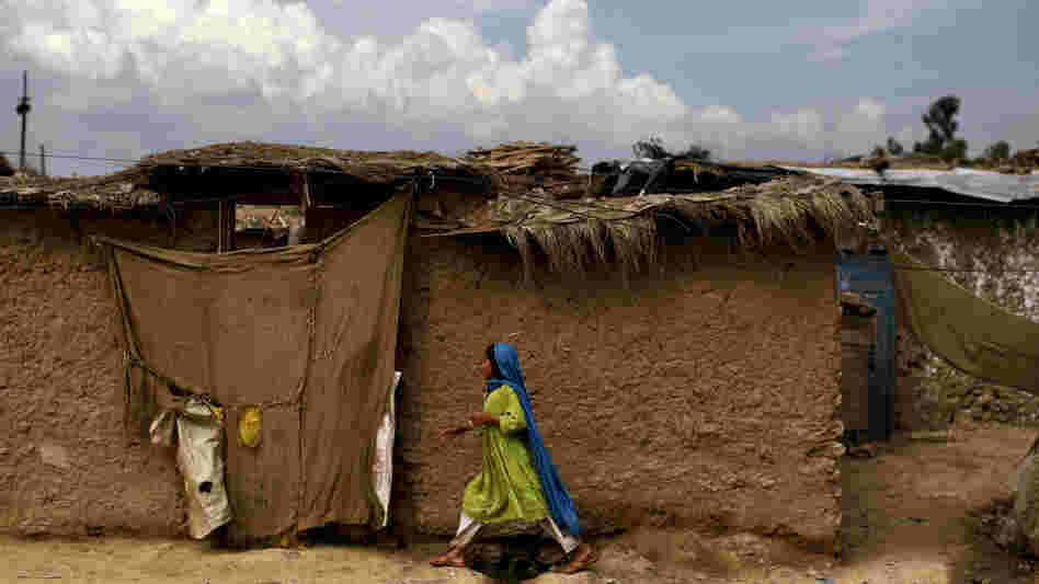 An Afghan refugee girl walks back to her home in a slum on the outskirts of the Pakistani capital, Islamabad, in August. She is one of an estimated 1.7 million mostly Afghan refugees in Pakistan.