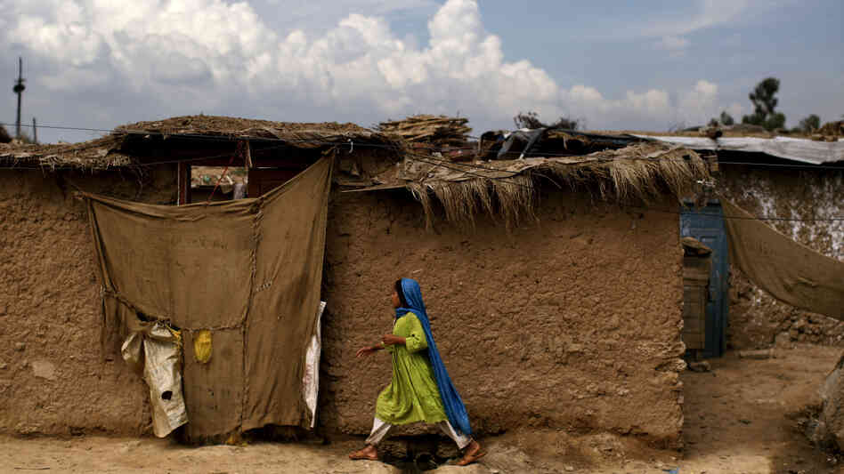 An Afghan refugee girl walks back to her home in a slum on the outskirts of the Pakistani capital, Islamabad, in August. She is one of an estimated 1.7 million mostly Afghan refugees in Pakistan.