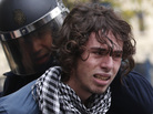 Riot policemen arrest a protester in Valencia on Wednesday during a general strike . Riot policemen arrest a protester in Valencia on Wednesday during a general strike .