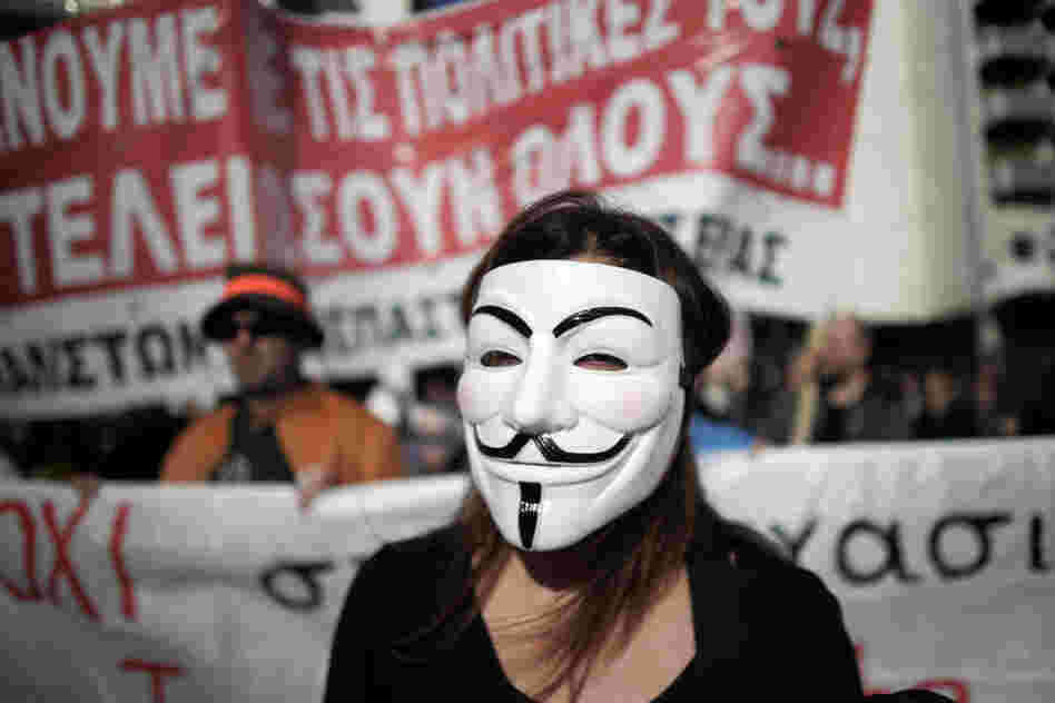A protester with a mask marches during an anti-austerity protest in Athens, Greece. 