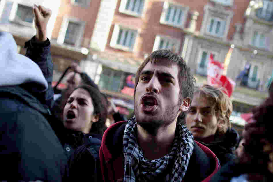 Demonstrators shout slogans into an open shop in Gran Via on Wednesday in Madrid, Spain.
