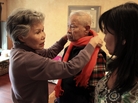 Shou-Mei Li, left, wraps a scarf around her husband Hsien-Wen Li, who is an Alzheimer's patient, as their daughter Shirley Rexrode, right, looks on, at their home in San Francisco. Shou-Mei Li, left, wraps a scarf around her husband Hsien-Wen Li, who is an Alzheimer's patient, as their daughter Shirley Rexrode, right, looks on, at their home in San Francisco.