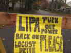 A plea to the Long Island Power Authority for electricity to be restored is posted on a barrier in Mastic Beach, N.Y. on Oct. 31, 2012. The south shore Long Island community was among the hardest hit by the storm that pounded the Northeast.