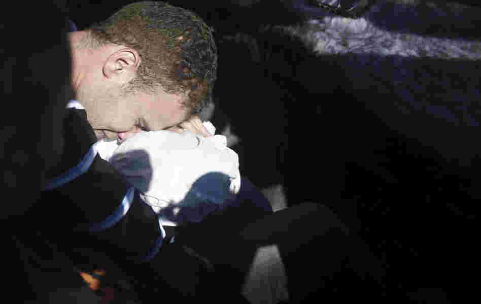 Jihad Masharawi, a Palestinian employee of BBC Arabic in Gaza, mourns over the body of his 11-month-old son.