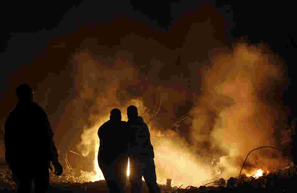 Palestinians try to extinguish fire following an Israeli air strike on Wednesday in Gaza City. Palestinians try to extinguish fire following an Israeli air strike on Wednesday in Gaza City.