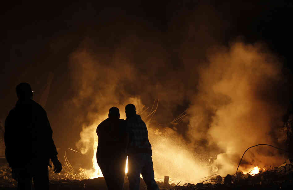 Palestinians try to extinguish fire following an Israeli air strike on Wednesday in Gaza City. Palestinians try to extinguish fire following an Israeli air strike on Wednesday in Gaza City.