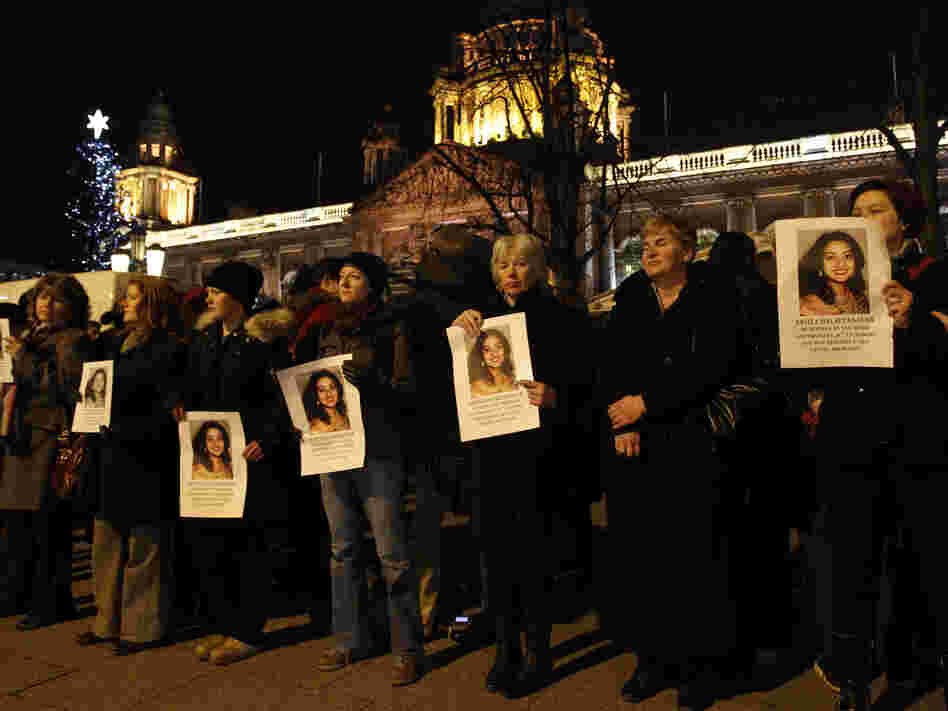 People hold pictures of Savita Halappanavar during a vigil outside Belfast City Hall, Northern Ireland, on Thursday. Halappanavar died Oct. 28 in Galway, Ireland, just days after she was denied an abortion.