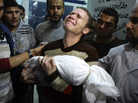 Jihad Masharawi weeps while he holds the body of his 11-month old son Ahmad, at Shifa hospital following an Israeli air strike on their family house, in Gaza City on Wednesday. Jihad Masharawi weeps while he holds the body of his 11-month old son Ahmad, at Shifa hospital following an Israeli air strike on their family house, in Gaza City on Wednesday.