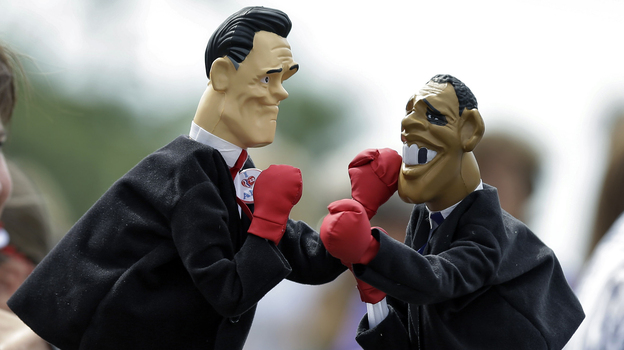 Lynn Armstrong Coffin and Eric Papalini box with puppets depicting Mitt Romney and President Obama in Sarasota, Fla., in September.
