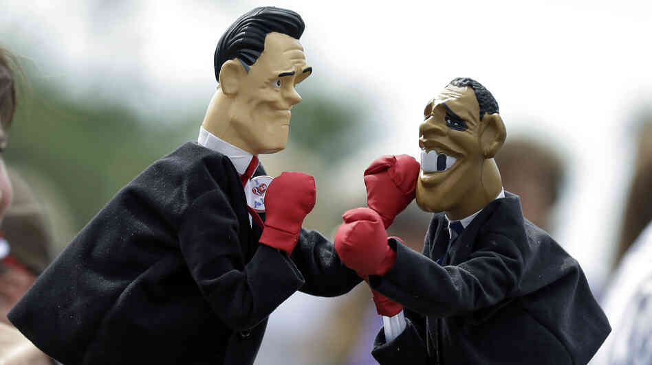 Lynn Armstrong Coffin and Eric Papalini box with puppets depicting Mitt Romney and President Obama in Sarasota, Fla., in September.