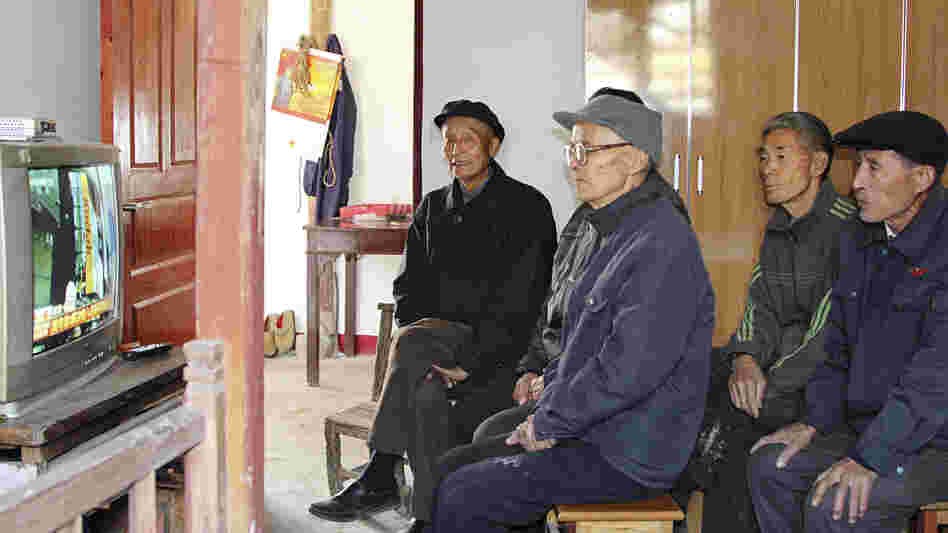 Villagers in Dongjiangai, in eastern China's Jiangsu province, watch the presentation of the Communist Party's new leadership on national TV Thursday. They say they support the new leaders because of the improvements government policies have brought to their village.