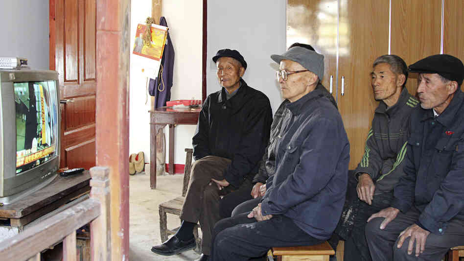 Villagers in Dongjiangai, in eastern China's Jiangsu province, watch the presentation of the Communist Party's new leadership on national TV Thursday. They say they support the new leaders because of the improvements government policies have brought to their village.
