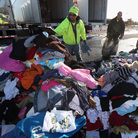 James Vouloukos (left) and William Ferris sort through donated clothes in Oceanside, N.Y. Relief workers say cash is more useful than donated supplies for their efforts. James Vouloukos (left) and William Ferris sort through donated clothes in Oceanside, N.Y. Relief workers say cash is more useful than donated supplies for their efforts.