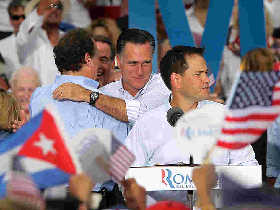 Florida Sen. Marco Rubio (foreground), a Cuban-American, introduces Republican presidential candidate Mitt Romney in Miami on Aug. 13 as Romney embraces former Florida Rep. Lincoln Diaz-Balart, who was born in Havana.