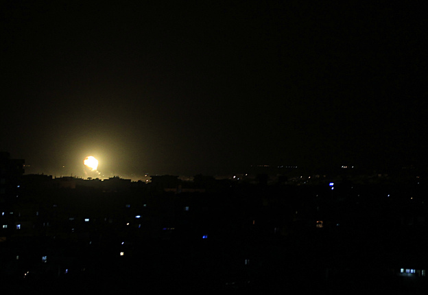 Fire rises from a building during an explosion following an Israeli strike in the town of Rafah in the southern Gaza Strip on Friday.