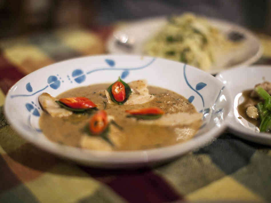 Myat Thu's wife created the Thai dishes on the menu. Thu says chicken panang curry is his wife's best dish. Chili peppers and Thai basil serve as flavorful garnishes.