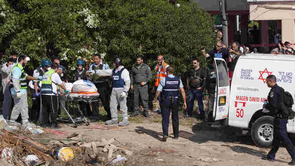 Rescue workers remove one of three Israelis killed in a rocket attack Thursday in southern Israel. Palestinian rocket attacks from the Gaza Strip have been limited to southern Israel over the past decade, but more powerful rockets have now reached the outskirts of Jerusalem and Tel Aviv, escalating the conflict. Rescue workers remove one of three Israelis killed in a rocket attack Thursday in southern Israel. Palestinian rocket attacks from the Gaza Strip have been limited to southern Israel over the past decade, but more powerful rockets have now reached the outskirts of Jerusalem and Tel Aviv, escalating the conflict.